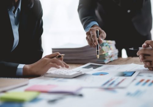 Successful Business Team Meeting Pointing at Graph for Strategic Planning and Growth. Teamwork Meeting with Graph Analysis and Collaboration. Corporate Collaboration and Analysis Concept.